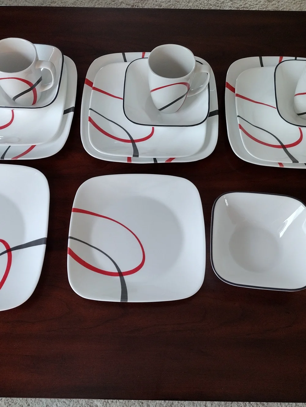 Corelle White Dinnerware Set with Red and Black Swirl Accents